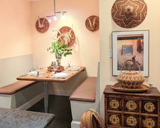 Asian reproduction nine drawer apothecary cabinet. Ugandan baskets. 