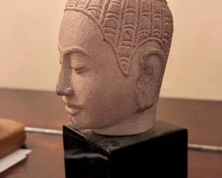 Carved sandstone with iron pin stationed on ebonized wood base. Queen Indradevi, the second wife of King Jayavarman VII was in the late 12th and early 13th century. 