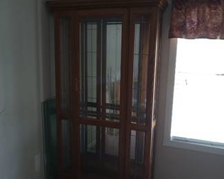 Lighted display case with glass shelves