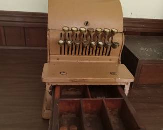 Inside working metal cash register with wood drawers
