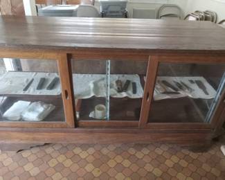 Display case with barbershop tools, combs, scissors, files.