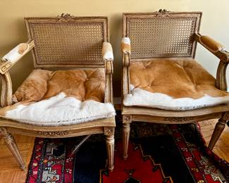Pair Vintage Cane armchairs with cowhide cushions. 
