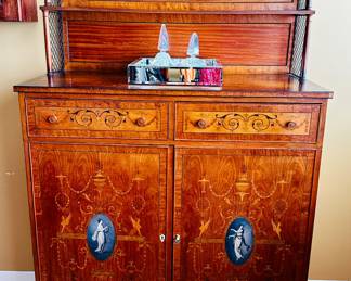 Antique inlaid chest with painted medallions .