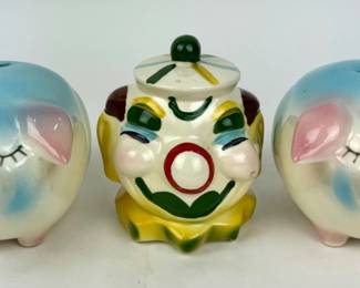#245 • Two Hull Corky Pig Piggy Banks and USA Clown Bank
WWW.LUX.BID