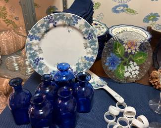 The blue bottles and white napkin rings are soldl.