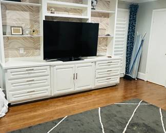 Tv, built in cabinetry, hardware, area rug. 