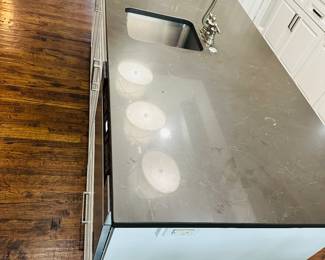 Kitchen island and counter top. Sink and faucet. 