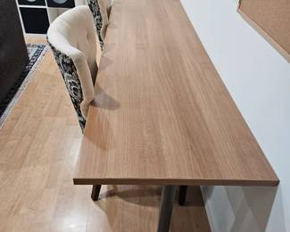 Long wooden desk with metal legs on wheels 