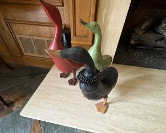 a trio of wooden ducks.