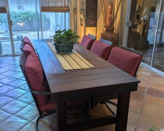 long style wood table on wheels, seats six.