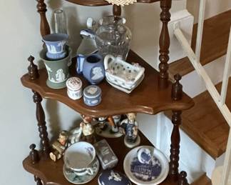 Antique corner five-tier shelf with assorted items.