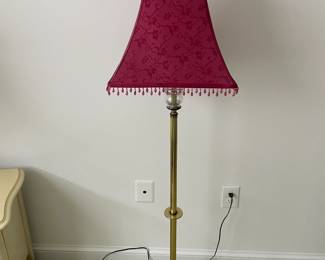 Floor lamp with fringed shade.