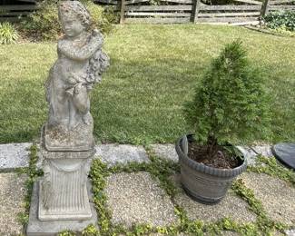 Pair of concrete garden statue cherub angel holding flowers and concrete planter with bush.