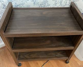 Small shelf on wheels.