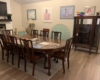 Antique Lifetime Furniture solid wood ball and claw feet Dining Table with eight leather upholstered chairs and five leaves. Matching curio cabinet. Mid-century modern side table. 1/2 inch thick round glass table top. Enfield sword and various antique pieces.