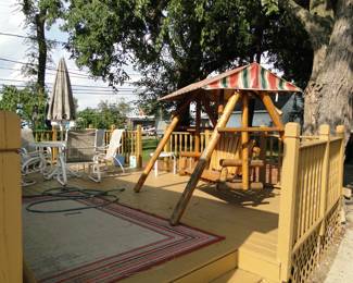 Nice patio table and chairs, along with a solid wood swing