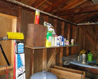 Assorted products for lawn and garden use and the top of a blue garbage can