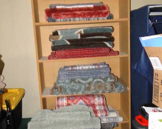 Lots and lots and lots of area rugs, neatly folded, and displayed nicely, lets keep it that way
