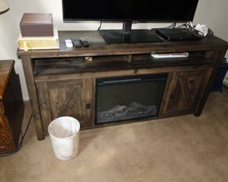 Electric fireplace, with storage cabinets on either side and perfect for watching a tv, which is also for sale too