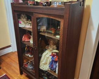 Arts and crafts cabinet with dolls