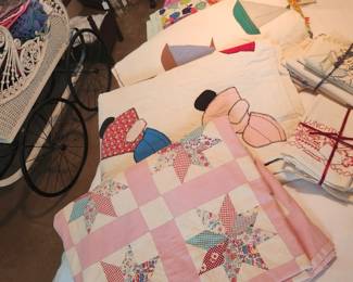 Quilts, and tea towels, and many linens