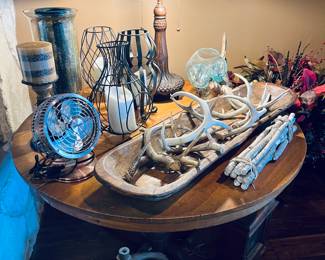 Antlers, decorative candle holders, vintage wooden bowl, Tiffany lamp.