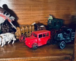 Vintage cast iron toys, wagons, cars, Antique hutch.