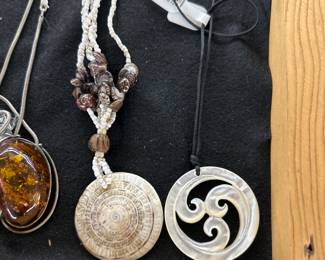 Left to right… 9.25 Amber brooch, earrings and necklace, antique, fossil and shell necklace, three center of energy mother of pearl necklace carved