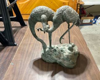 Heavy metal yard art. One of the birds has a fish in it’s beak.