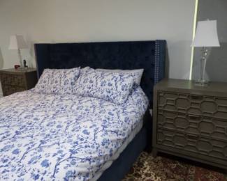 King size rich blue upholstered bed with nail head trim, pair of night tables & lamps, area rug
