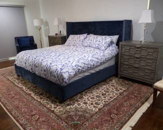King size rich blue upholstered bed with nail head trim, pair of night tables & lamps, area rug