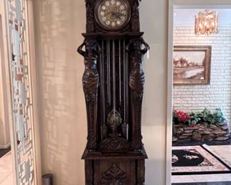 A Gazo Family ’The Californian’ 8ft tall ‘Open Well’ Case Clock Featuring Carved Oak Draped Figures with Etched Solid Brass Dial with Porcelain Numerals-(96”x27”x17”)..