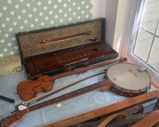 Sunroom 
Antique violin bow shipping case, cello bow, banjo, ukelin
