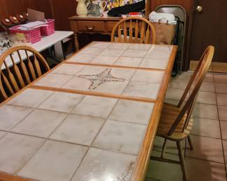 Ceramic top table and four arrow back chairs, shown with leaf. Matching hutch shown with blue and yellow display of plates. Table and chairs priced separately, hutch has ceramic top as well.
