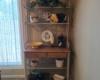 Baker's rack with many blue and yellow decorative pieces.