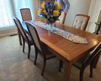 Dining table and six chairs (one captain chair) in excellent condition including one of two leaves never opened from factory. Matches mid-century china cabinet, also in excellent condition.