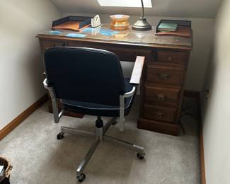One of three desks and 3 office chairs