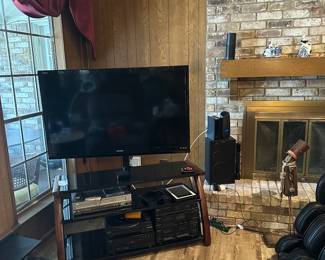 Sharp 45 inch smart TV with stand. 
Sony entertainment center with DVD/VCR player, cassette tape player, CD player, phonograph turntable, and AM/FM tuner. 