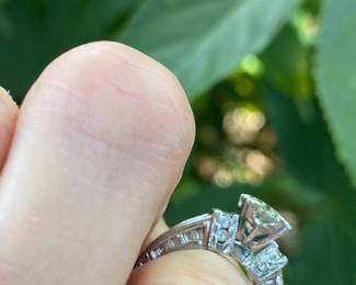 #148 - One, round European cut diamond of about 1.54 ct (VVS2, L-N color range) One platinum fifty-seven stone, cast made ring. 14 round full cut diamonds 1.50mm. (SI 1 - GH color range). 42 baguette cut diamonds (SI 1- GH color range) -Size 5- Appraisal & price available upon request.