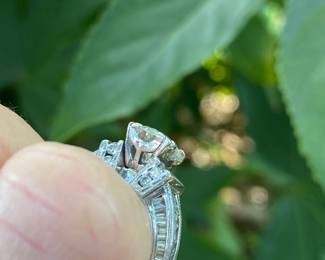 #148 - One, round European cut diamond of about 1.54 ct (VVS2, L-N color range) One platinum fifty-seven stone, cast made ring. 14 round full cut diamonds 1.50mm. (SI 1 - GH color range). 42 baguette cut diamonds (SI 1- GH color range) - Size 5- Appraisal & price available upon request.