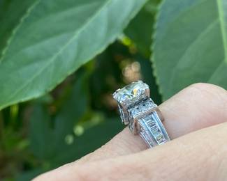 #148 - One, round European cut diamond of about 1.54 ct (VVS2, L-N color range) One platinum fifty-seven stone, cast made ring. 14 round full cut diamonds 1.50mm. (SI 1 - GH color range). 42 baguette cut diamonds (SI 1- GH color range) - Size 5- Appraisal & price available upon request.