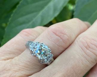 #148 - One, round European cut diamond of about 1.54 ct (VVS2, L-N color range) One platinum fifty-seven stone, cast made ring. 14 round full cut diamonds 1.50mm. (SI 1 - GH color range). 42 baguette cut diamonds (SI 1- GH color range) - Size 5- Appraisal & price available upon request.