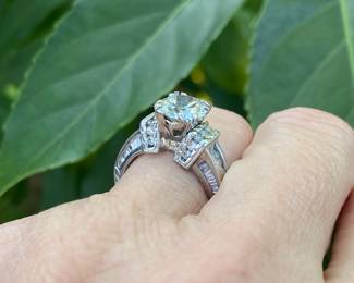 #148 - One, round European cut diamond of about 1.54 ct (VVS2, L-N color range) One platinum fifty-seven stone, cast made ring. 14 round full cut diamonds 1.50mm. (SI 1 - GH color range). 42 baguette cut diamonds (SI 1- GH color range) - Size 5- Appraisal & price available upon request.