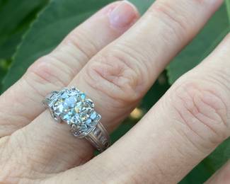 #148 - One, round European cut diamond of about 1.54 ct (VVS2, L-N color range) One platinum fifty-seven stone, cast made ring. 14 round full cut diamonds 1.50mm. (SI 1 - GH color range). 42 baguette cut diamonds (SI 1- GH color range) - Size 5-Appraisal & price available upon request.