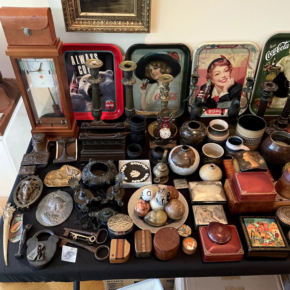 Bulova Frank Lloyd Wright clock, Coca Cola trays including an ORIGINAL 1912 Hamilton King Girl, collection of small boxes, small mid century studio art pottery pieces, grand tour oil lamps, French Empire candlesticks, stone eggs, Bradley & Hubbard bookends, French pocket watch holder, Wedgwood, metalware