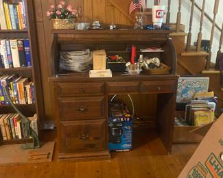 roll top desk, decorative plates, lighters on top 
