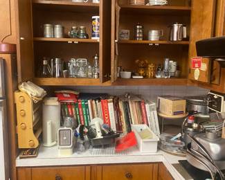 cookbooks, kitchen utensils, small crocks, …