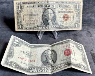 A 1935A Hawaii Silver Certificate in well circulated condition and a 1953 $2 Red Seal Star. The $2 bill is crisp but has a few center folds.