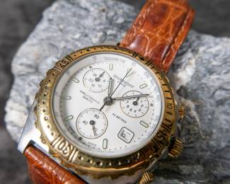 Givenchy Chronograph quartz watch in the original box/case on a genuine leather band. Will at least need a new battery to operate. 43mm case size with bezel and 46.5mm lug to lug.