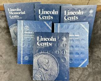 Six Whitman Lincoln Cent coin folders. Two of the folders are 100% complete, and the others are partially filled.
